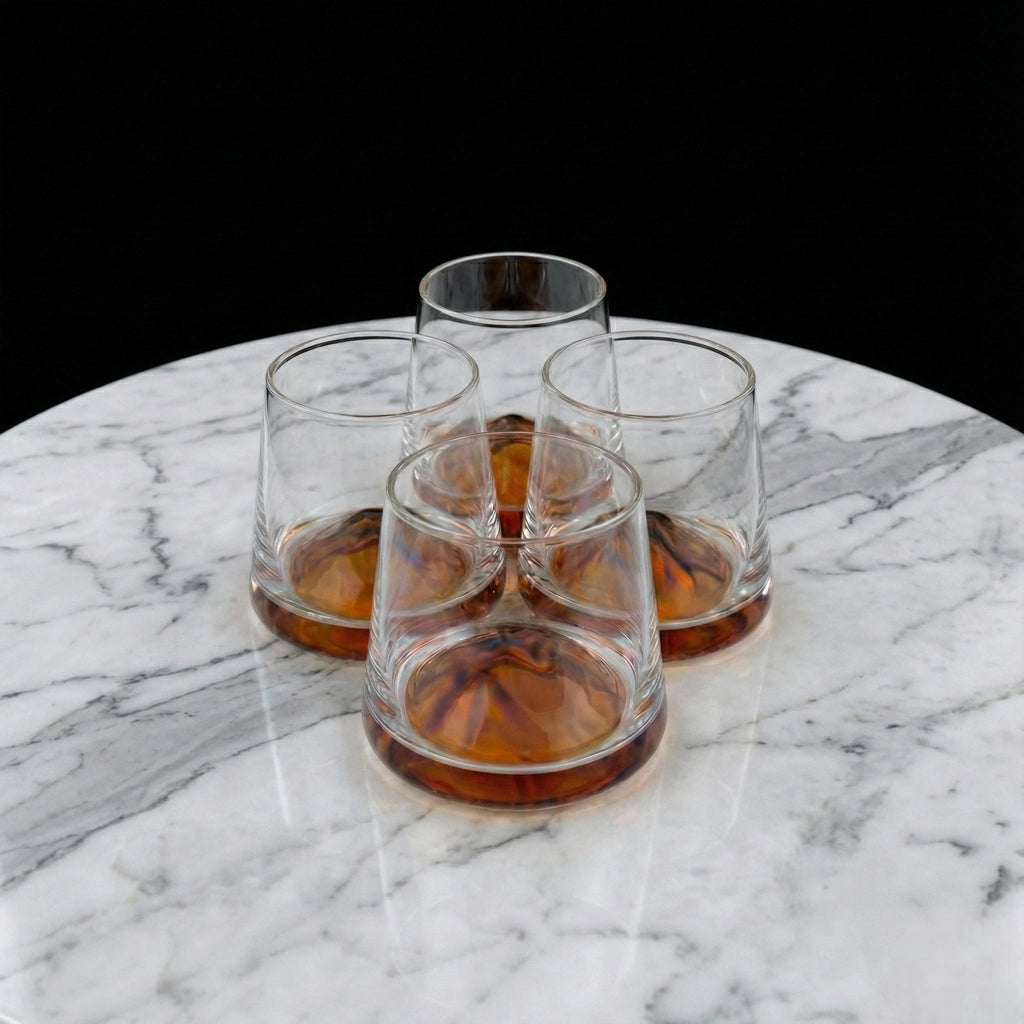 Contemporary whiskey tumbler glasses featuring artistic amber accents for premium barware and elegant entertaining arrangements