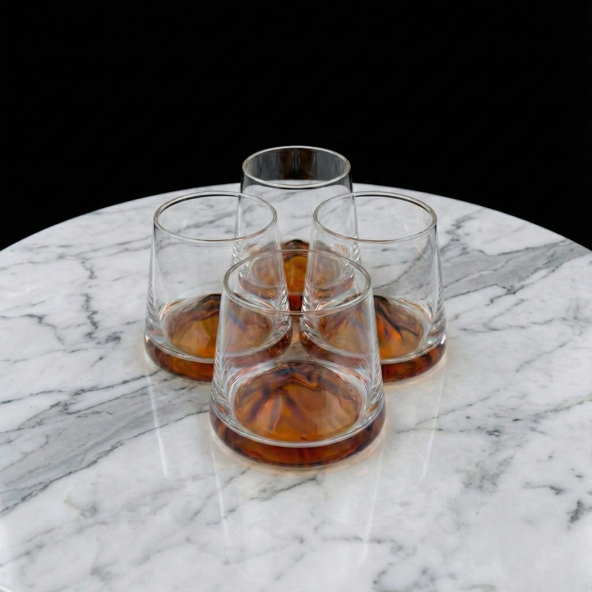 Contemporary whiskey tumbler glasses featuring artistic amber accents for premium barware and elegant entertaining arrangements