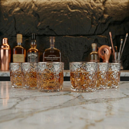 Designer whiskey glasses for bourbon and scotch serving in premium home bar arrangement