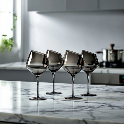 set of modern smoked wine glasses with angular bowl design on marble countertop, elegant glassware for home bar, dining table styling and hosting
