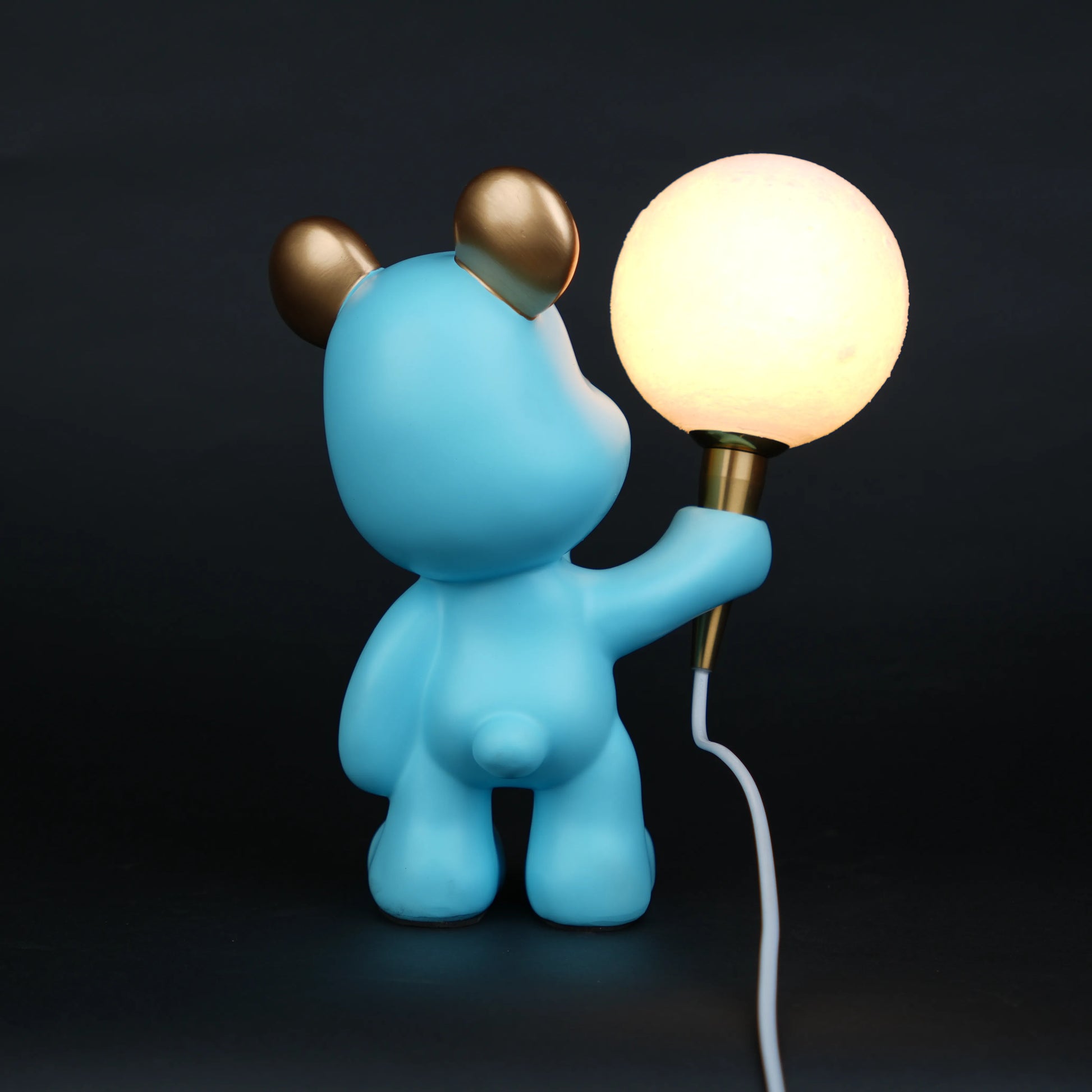 blue bear lamp holding glowing moon bulb with gold accents