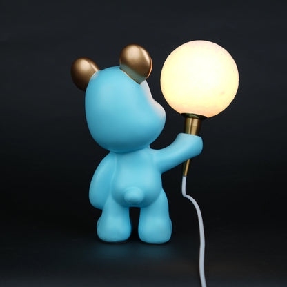 blue bear lamp holding glowing moon bulb with gold accents