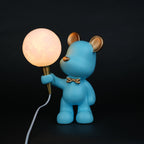 blue bear lamp holding glowing moon bulb with gold accents