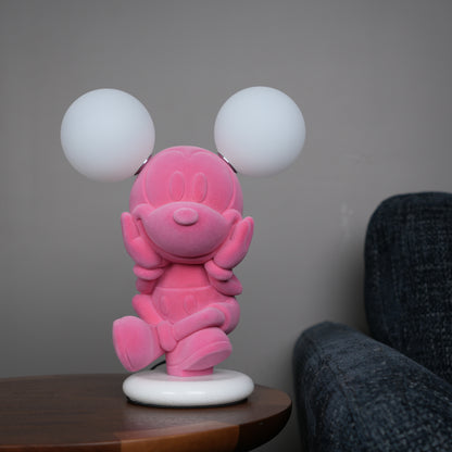 Pink figurine lamp with two warm glowing orb lights on top.