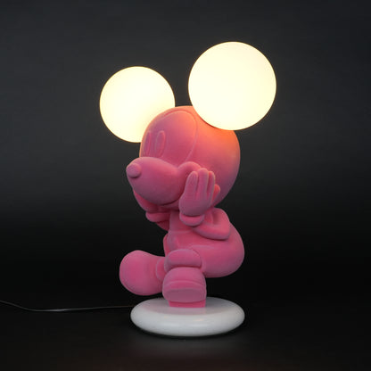Pink figurine lamp with two warm glowing orb lights on top.