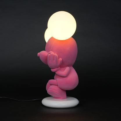 Pink figurine lamp with two warm glowing orb lights on top.