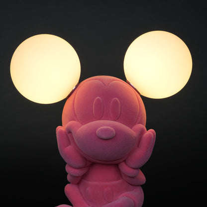 Pink figurine lamp with two warm glowing orb lights on top.