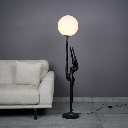 Elegant Human Stretch Lamp – tall matte black human-form sculpture holding a glowing orb floor lamp.