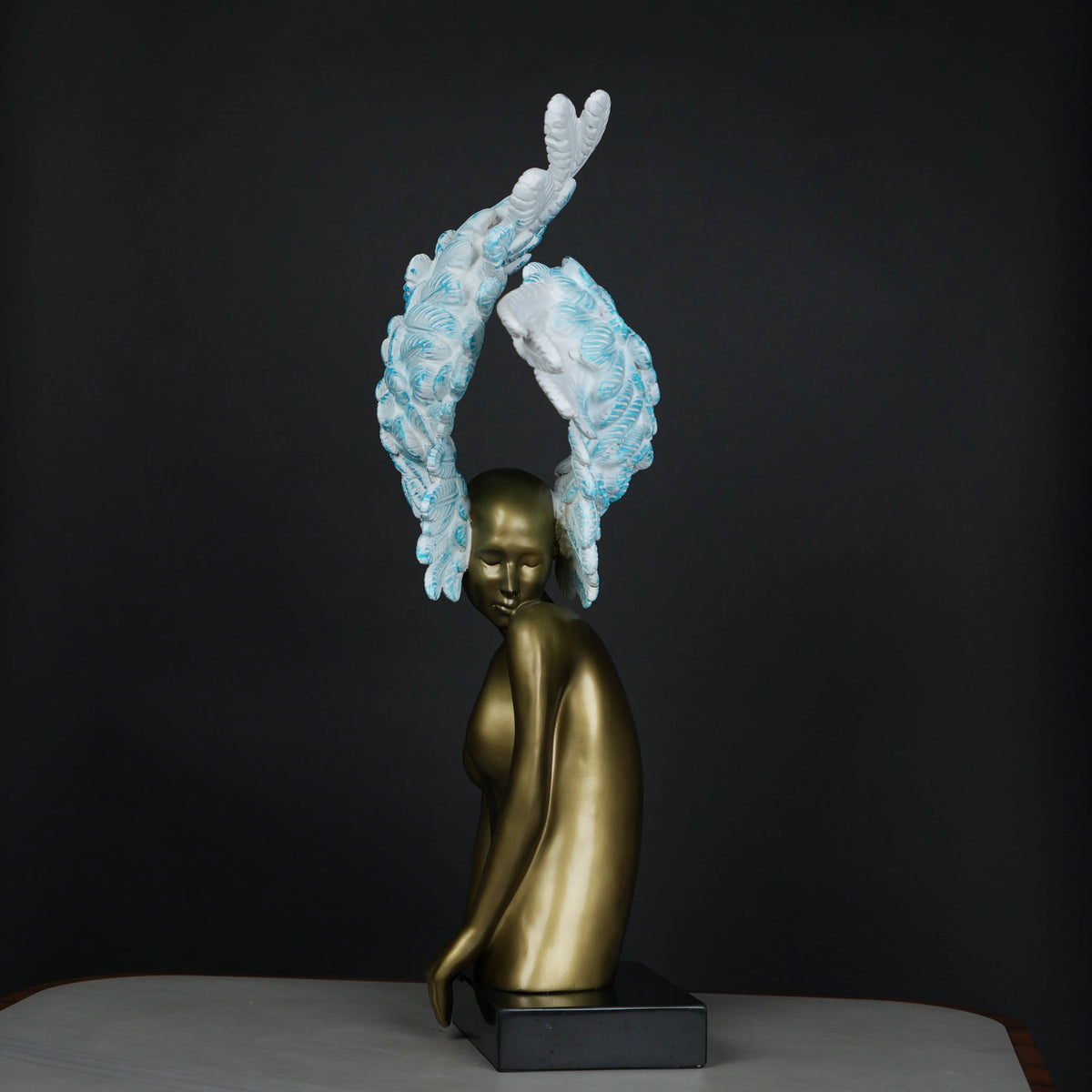 Luxury feather head figurine with detailed layered wing design and metallic finish for elegant tabletop decor arrangements