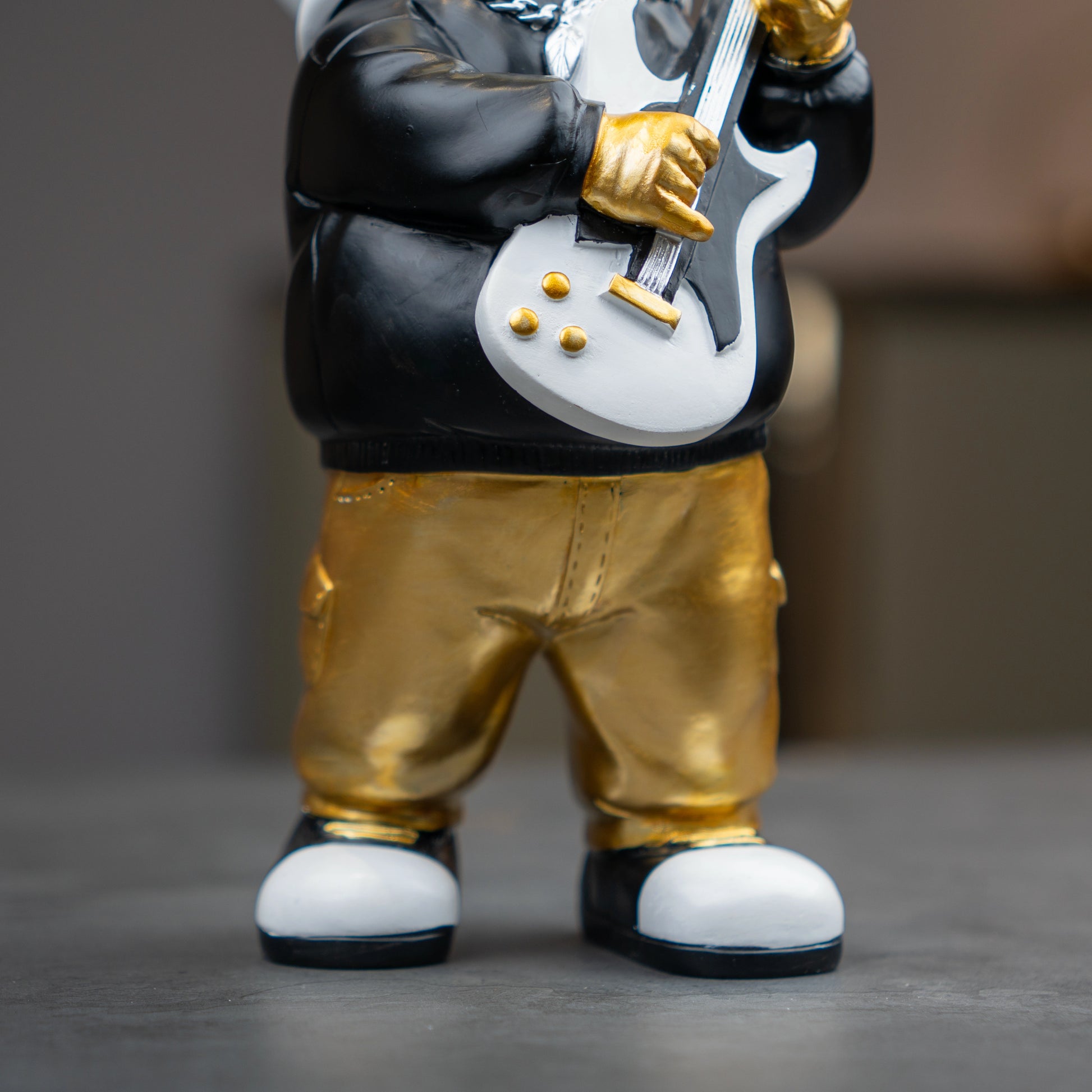 Small astronaut figurine playing guitar with gold helmet and metallic finish — Cosmic Rockstar Figurine by Ghar Art, handcrafted modern tabletop decor collectible.
