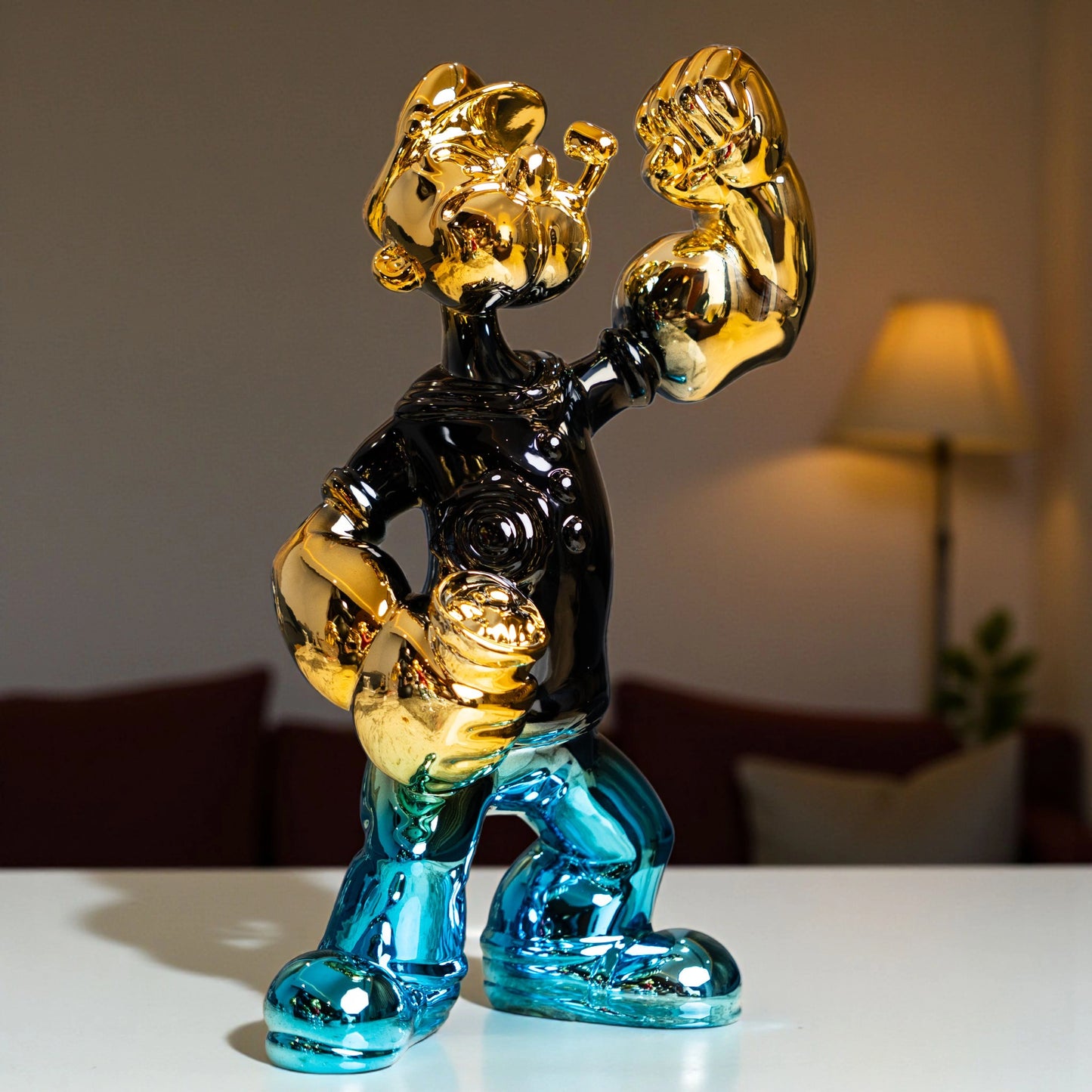 Aqua and gold metallic resin figurine in a dynamic pose — luxury high-gloss decorative sculpture by Ghar Art.