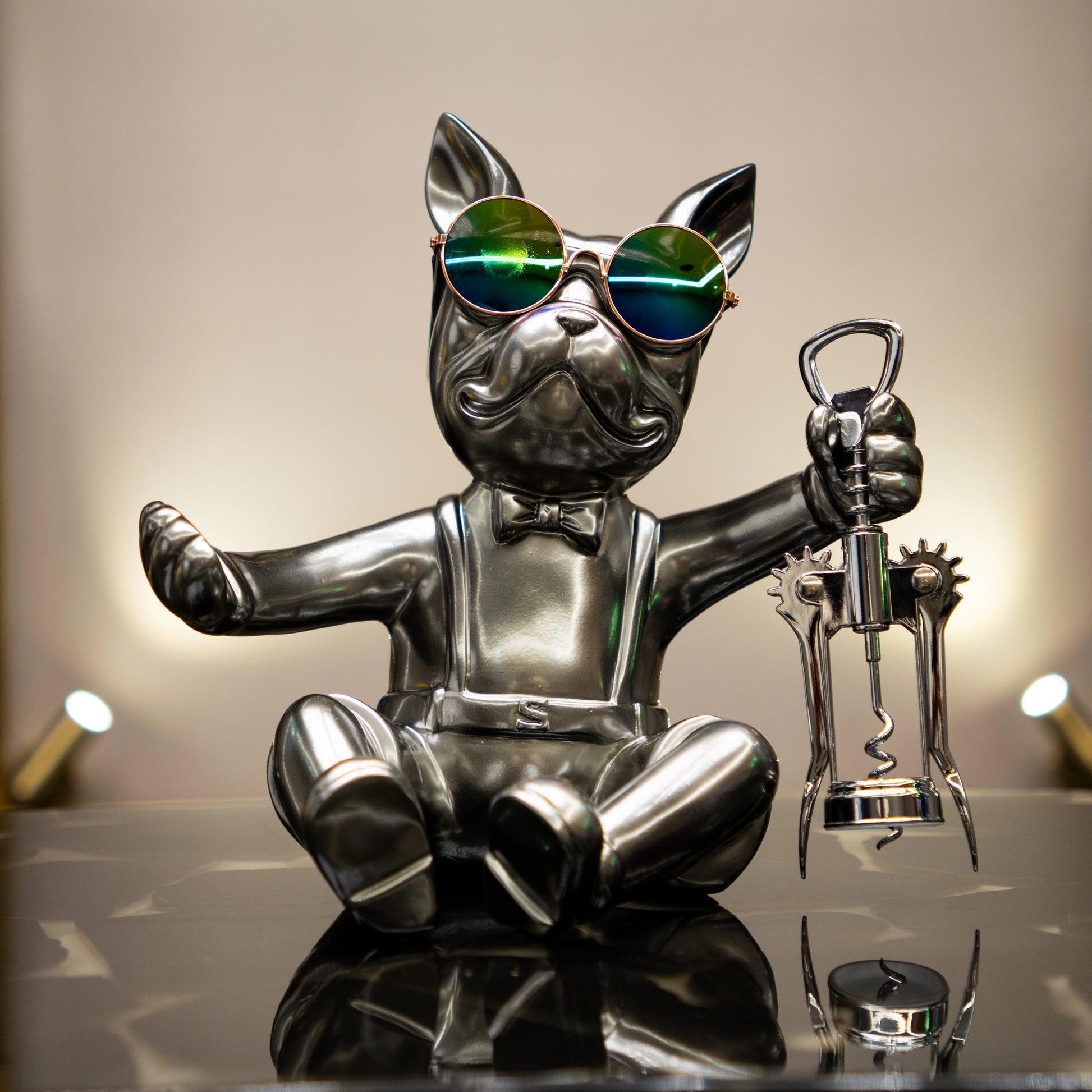 Metallic bulldog figurine holding corkscrew and wearing sunglasses — Boozy Bulldog wine holder by Ghar Art, luxury tabletop bar décor collectible.