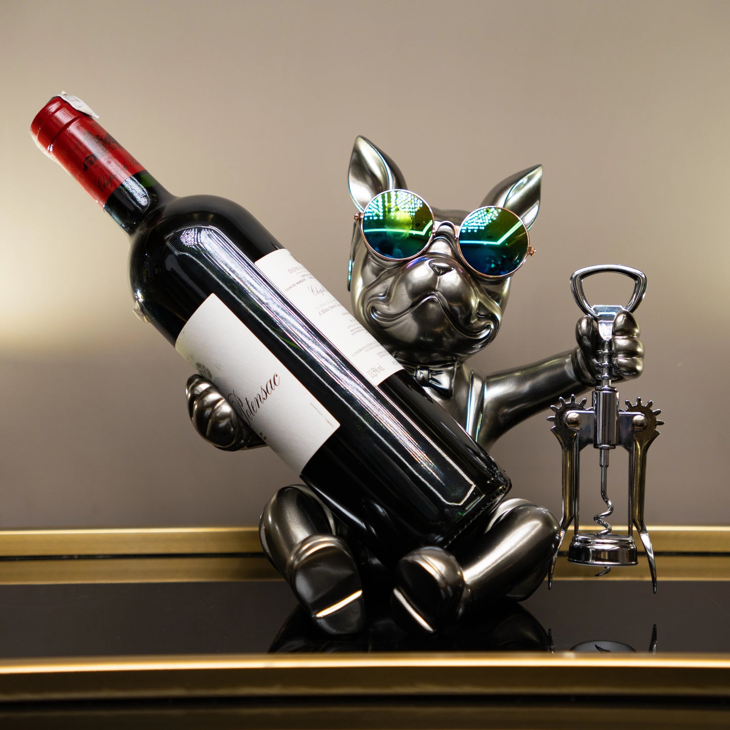 Metallic bulldog figurine holding corkscrew and wearing sunglasses — Boozy Bulldog wine holder by Ghar Art, luxury tabletop bar décor collectible.