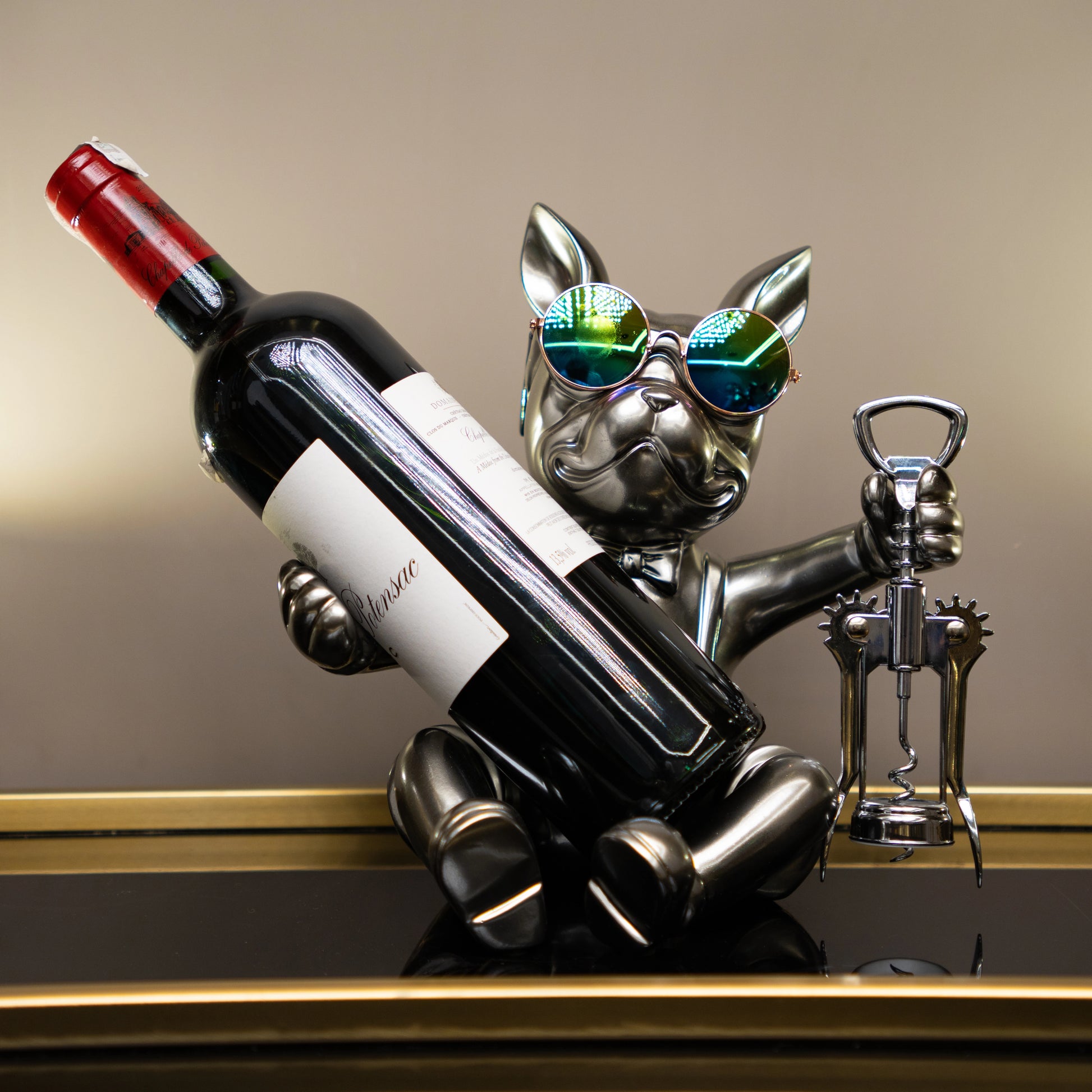 Metallic bulldog figurine holding corkscrew and wearing sunglasses — Boozy Bulldog wine holder by Ghar Art, luxury tabletop bar décor collectible.