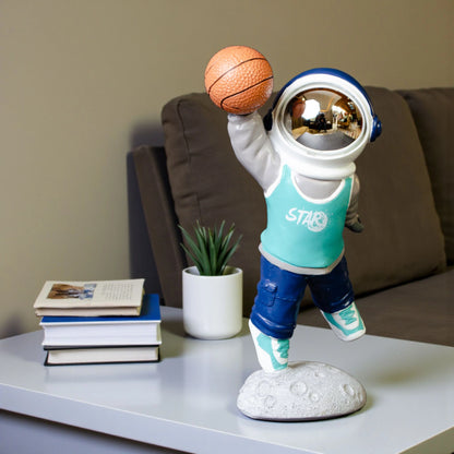 Astronaut figurine dribbling a basketball on a moon base with teal jersey and gold visor