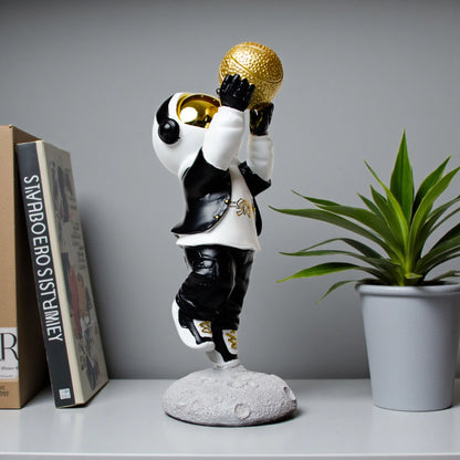 Astronaut figurine in black-and-white streetwear shooting a gold basketball on a moon base — Cosmic Shooter Figurine by Ghar Art.