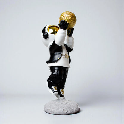 Astronaut figurine in black-and-white streetwear shooting a gold basketball on a moon base — Cosmic Shooter Figurine by Ghar Art.