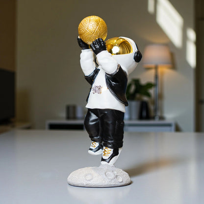 Astronaut figurine in black-and-white streetwear shooting a gold basketball on a moon base — Cosmic Shooter Figurine by Ghar Art.