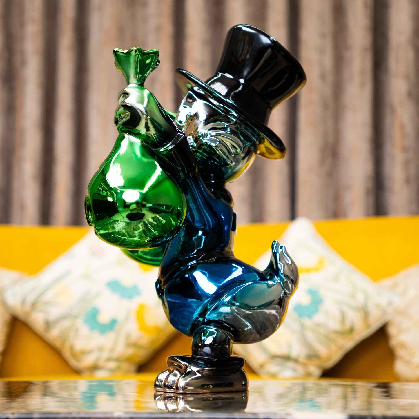 Metallic green and blue duck sculpture holding gold money bags — Money Maestro Sculpture by Ghar Art, handcrafted luxury pop-art collectible for modern decor.