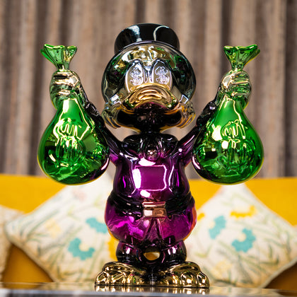 Pink metallic duck sculpture holding emerald money bags — Money Maestro – Pink Edition by Ghar Art, handcrafted luxury pop-art collectible.