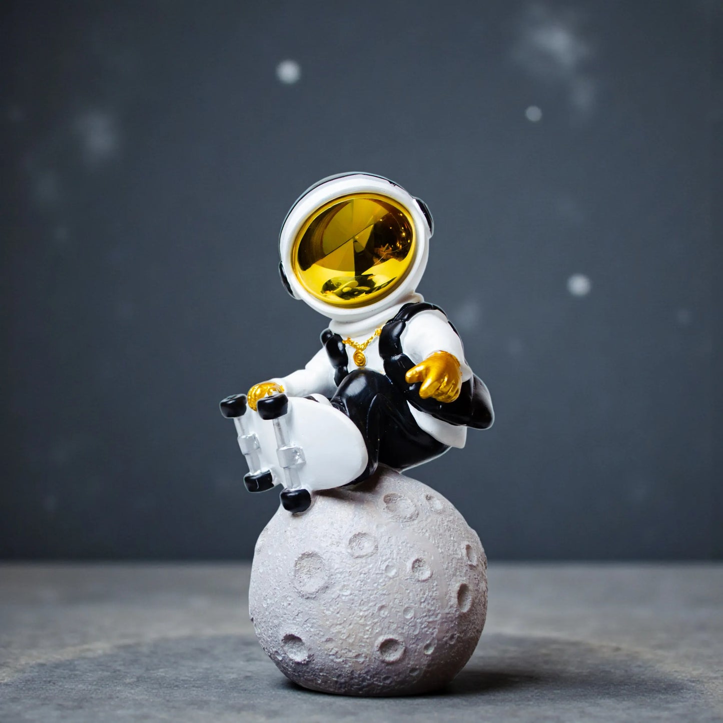 white cosmic skater astronaut figurine sitting on moon with skateboard