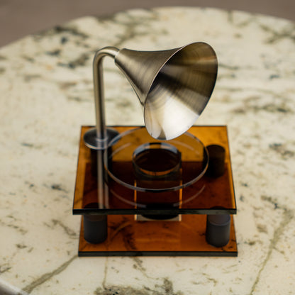 brown retro-style acoustic amplifier decor piece with gold funnel top