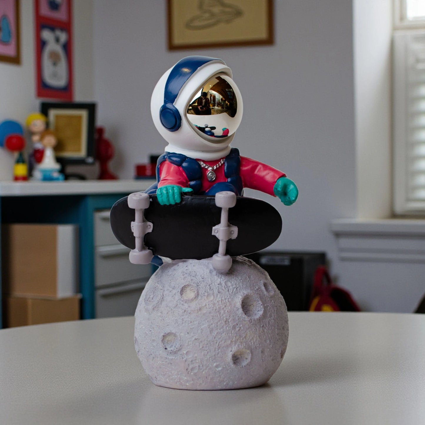 Astronaut skateboard figurine on moon base in multicolor resin