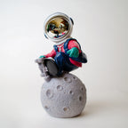 Artistic astronaut decorative figurine with moon base and colorful detailing for premium interiors