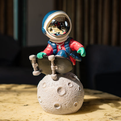 Astronaut skateboard figurine on moon base in multicolor resin