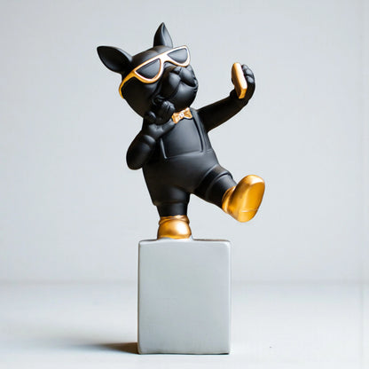 Black resin bulldog figurine trio with gold accents displayed on modern pedestal blocks