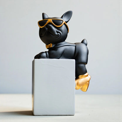 Black resin bulldog figurine trio with gold accents displayed on modern pedestal blocks