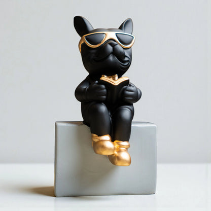 Black resin bulldog figurine trio with gold accents displayed on modern pedestal blocks