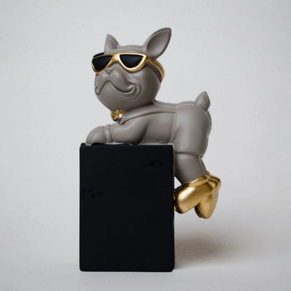 Grey resin bulldog figurine trio with gold accents displayed on black pedestal blocks