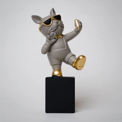 Grey resin bulldog figurine trio with gold accents displayed on black pedestal blocks