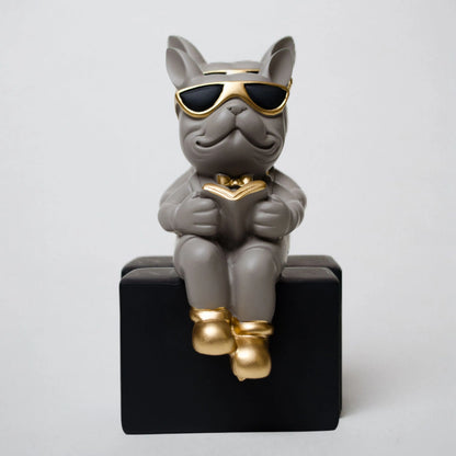 Grey resin bulldog figurine trio with gold accents displayed on black pedestal blocks