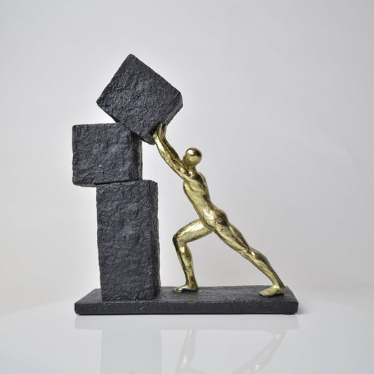 Vertical gold human struggle sculpture pulling textured sphere on stepped base