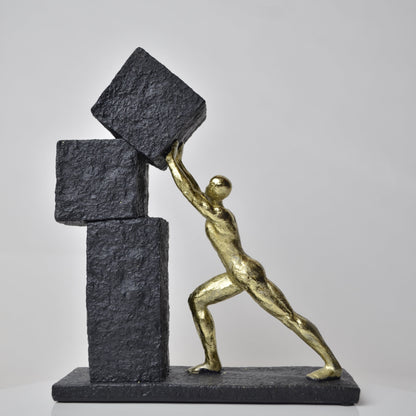 Vertical gold human struggle sculpture pulling textured sphere on stepped base