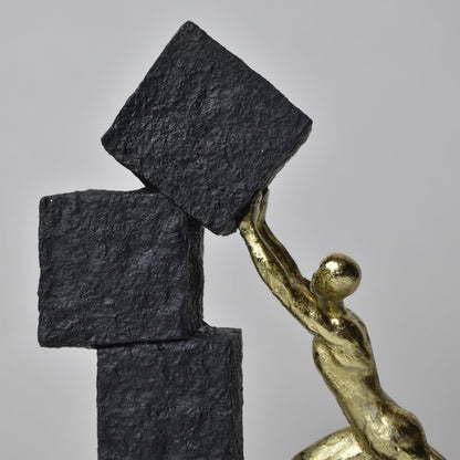 Vertical gold human struggle sculpture pulling textured sphere on stepped base