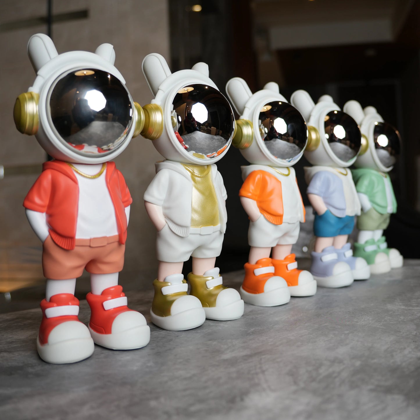 Astronaut figurine with orange jacket and chrome visor.