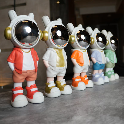 Astronaut figurine with orange jacket and chrome visor.