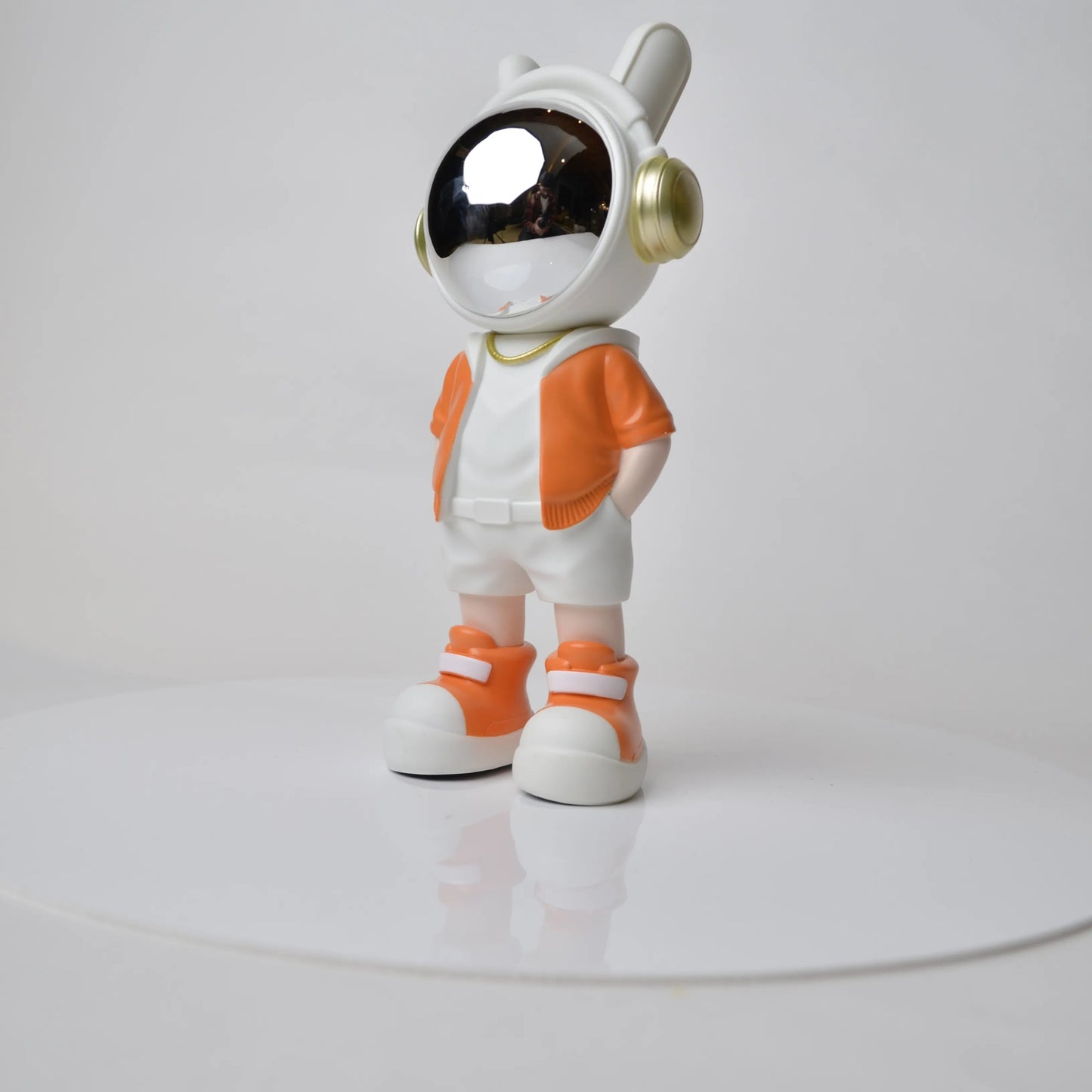 Astronaut figurine with orange jacket and chrome visor.