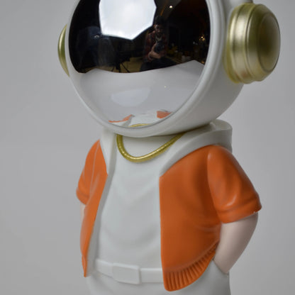 Astronaut figurine with orange jacket and chrome visor.