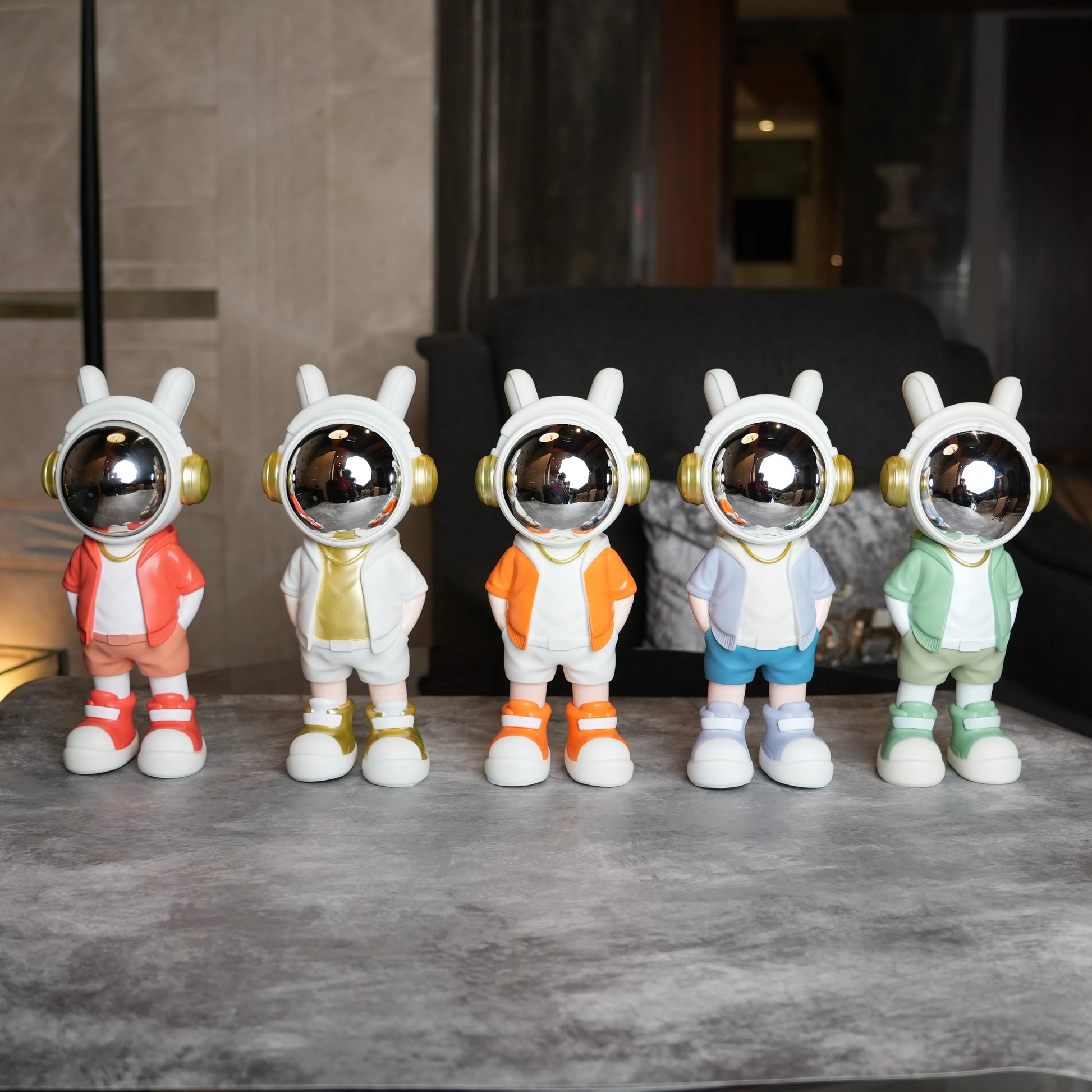 Astronaut figurine with orange jacket and chrome visor.