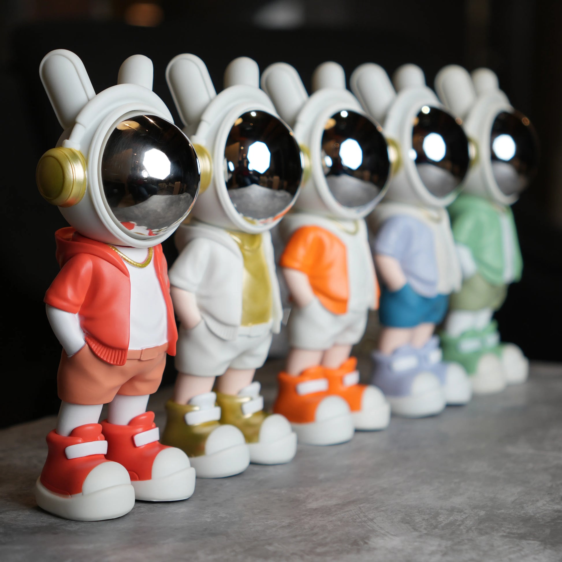 Astronaut figurine with orange jacket and chrome visor.