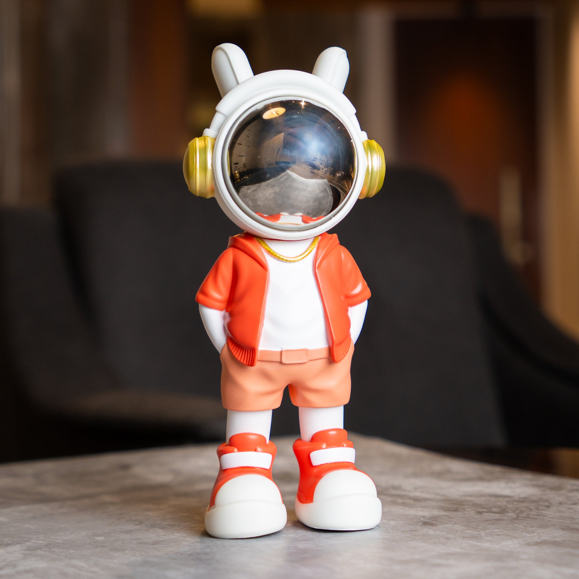 Astronaut figurine with coral jacket and chrome visor.