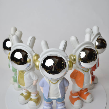 Astronaut figurine with chrome visor wearing blue shorts and lavender jacket.