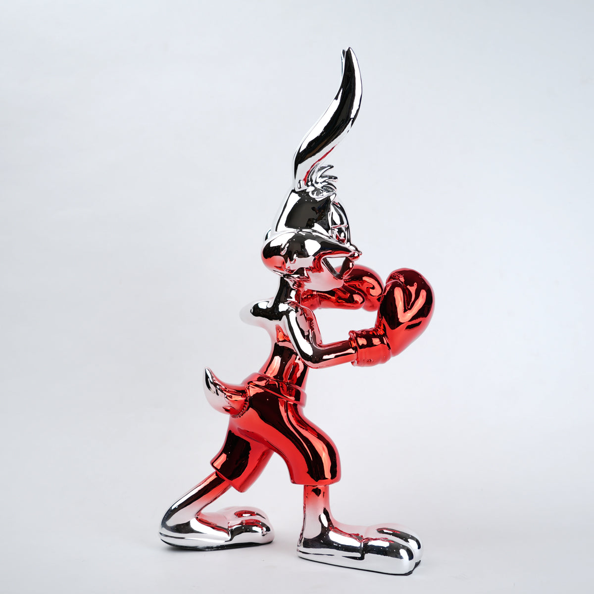 Metallic red and black cartoon character figurine on a white background