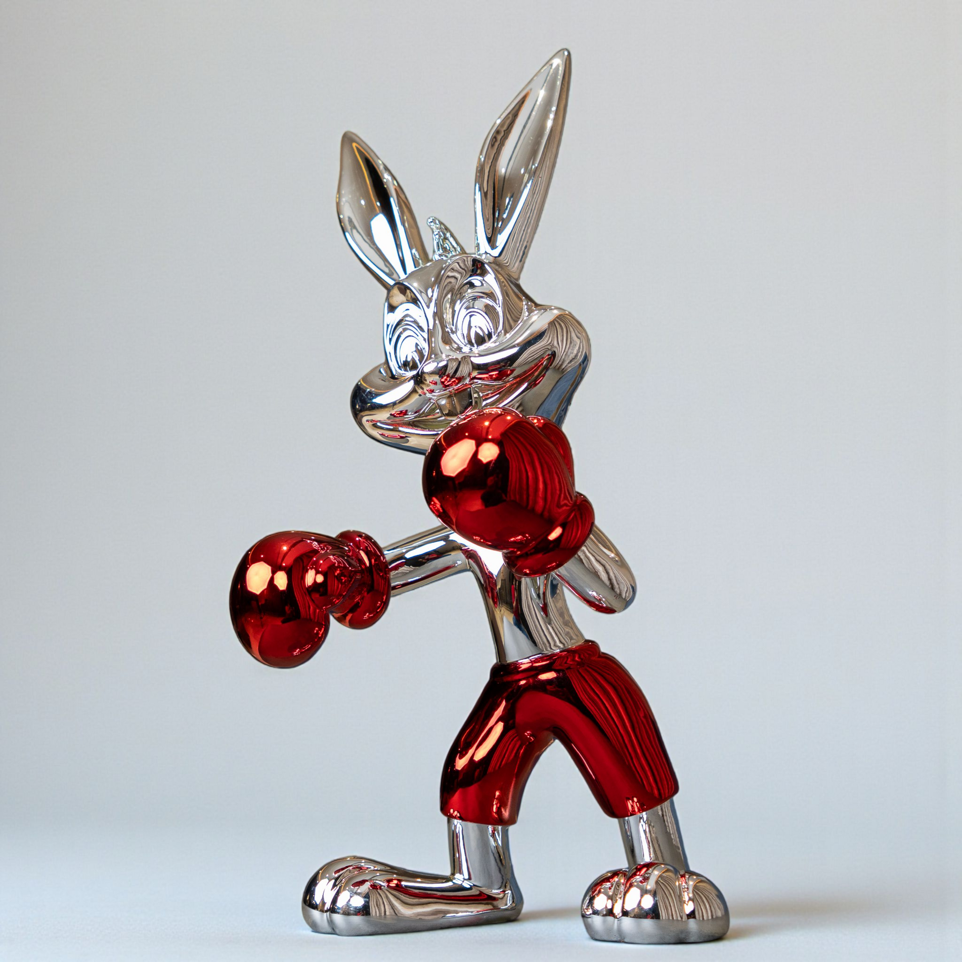 Resin bunny boxer figurine with chrome black finish and scarlet red gloves and shorts