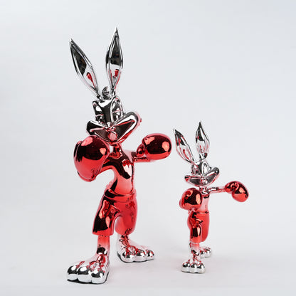 Two metallic red and silver rabbit figures on a white background