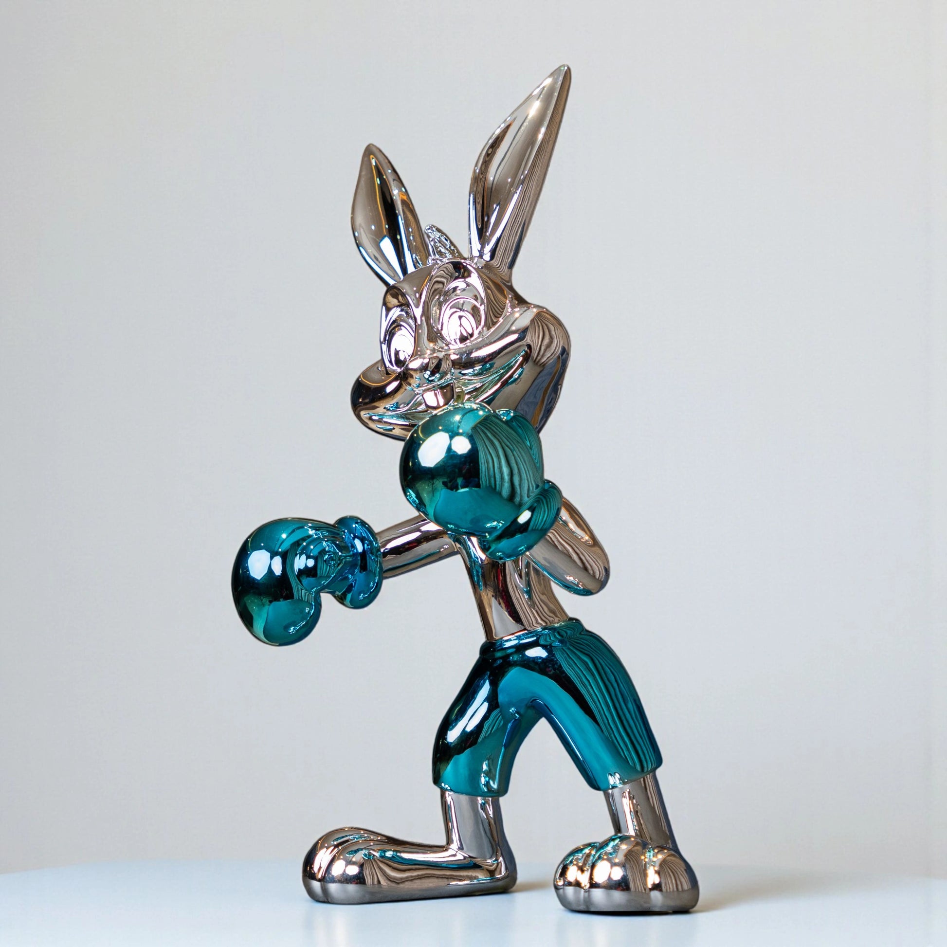 Resin bunny boxer figurine with chrome silver finish and aqua blue gloves and shorts